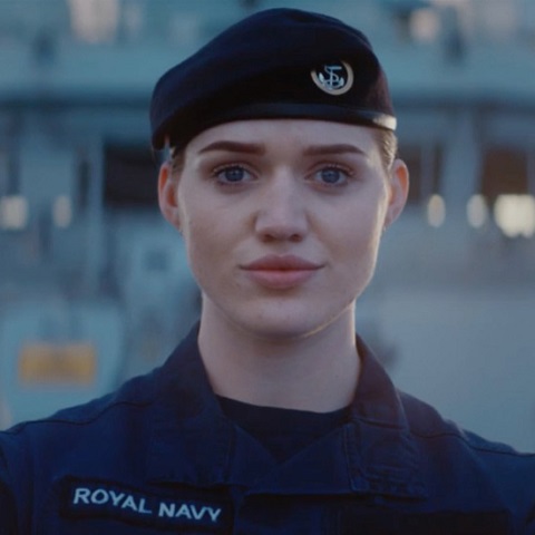 royal navy engineer on deck in uniform looking straight to camera