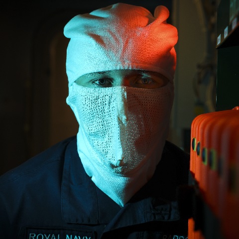 An Above Water Tactical wears anti flash in the ships operations room as part of their personal protective gear