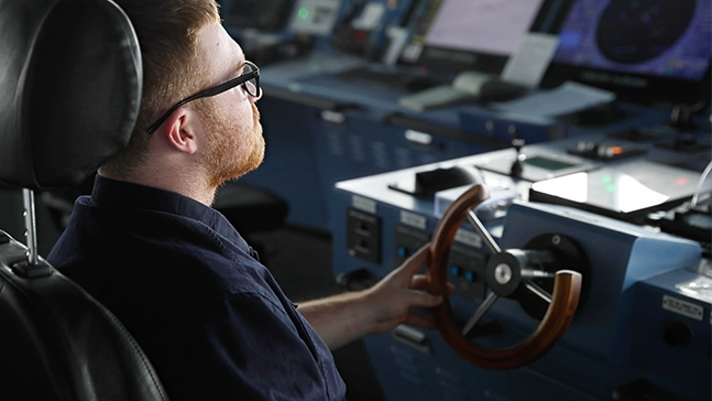 Seaman at the helm of a ship