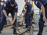 A group of Royal Navy ratings at work on board ship. 