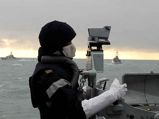 Royal Navy personnel at work at sea. 
