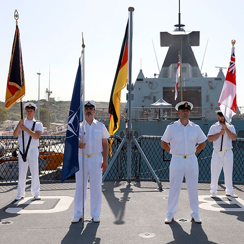 Personnel standing on board a ship