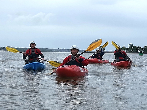 group of sit on top kayakers on calm waters