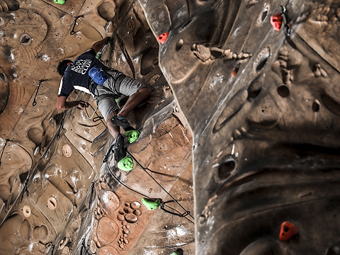 naval climber taking on realistic cliff face wall