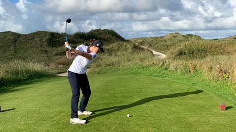 Female golfer taking a swing