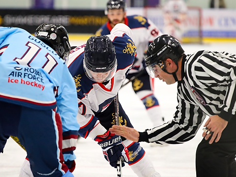 ice hockey players and referee at face-off