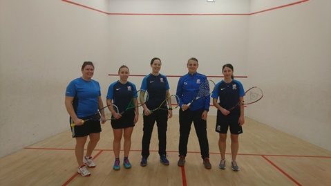 royal navy squash team shot, dressed in blue posing with rackets to camera