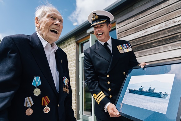 Commander Rich Thurman presents Horace with a framed picture of HMS Queen Elizabeth