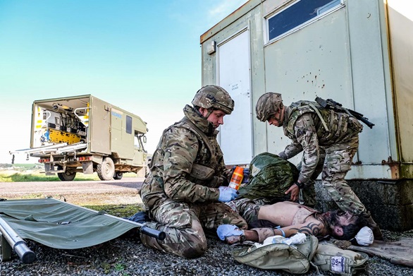 Members of the Commando Logistic Regiment Medical Squadron tend to battlefield injuries