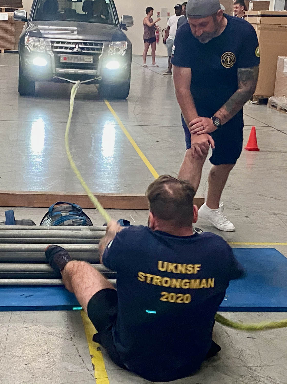 A Royal Navy sailor pulls car in strongest man compeition
