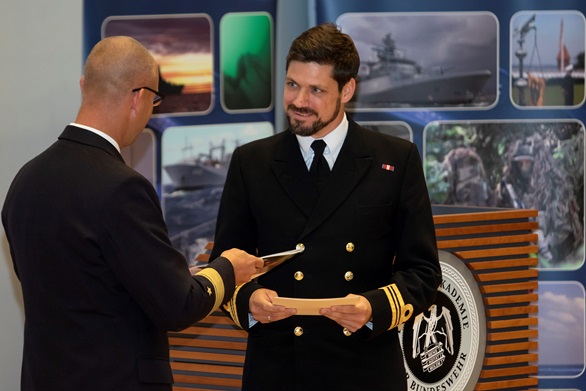 Lieutenant Commander David Roberts (right) receives the top naval student award from the Commander of the German Navy's Baltic forces, Flotillenadmiral (Commodore) Christian Bock