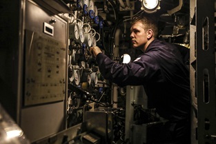 A weapon engineer on a Trafalgar-class submarine checks one of his systems
