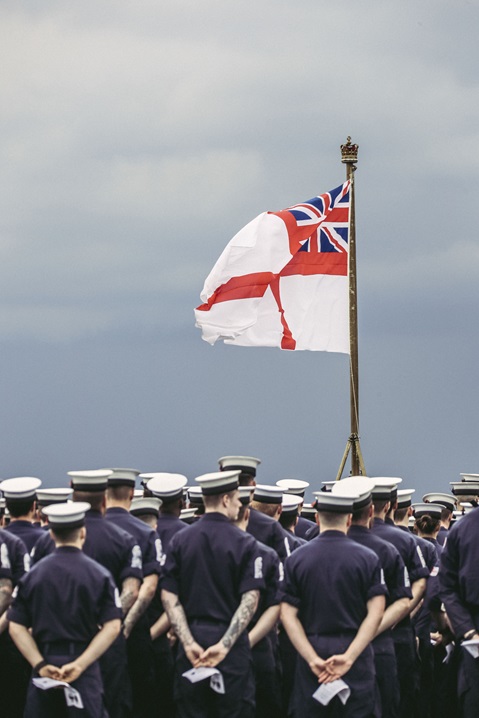 HMS Albion's White Ensign billows in the Med during the flight deck service