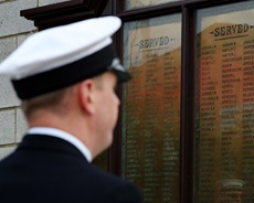 One of HMS Protector's sailors studies the roll of honour at the docks in Teesside