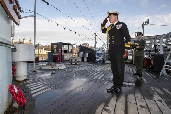 Rear Admiral Iain Lower salutes the fallen of the Arctic Convoy on HMS Belfast's Quarterdeck