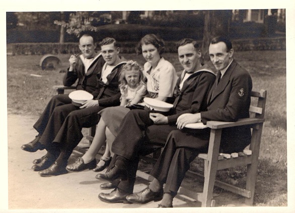 Four sailors with Mrs Casey and one of her daughters in a New York park