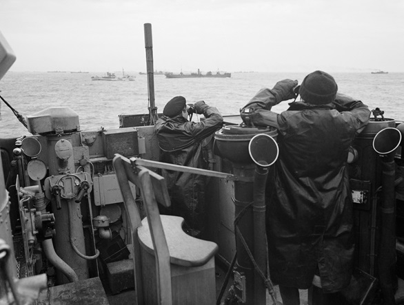 Officers on a destroyer's bridge keep a lookout over a convoy in the Atlantic October 1941