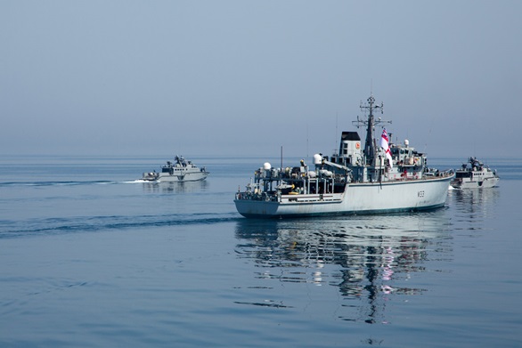 Two US Mk VI Patrol boats shepherd HMS Brocklesby