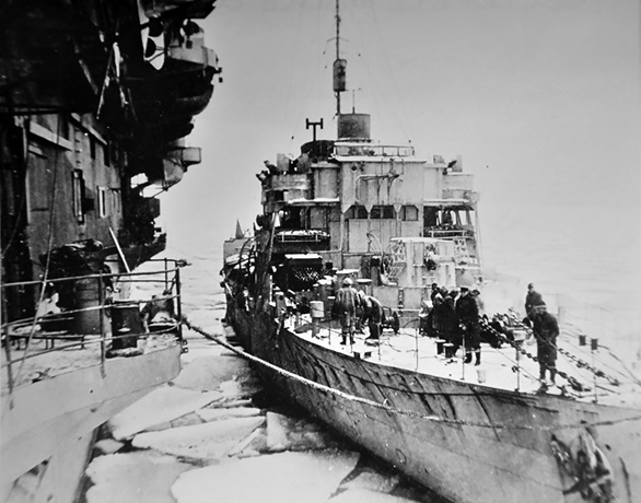 HMS Honeysuckle comes alongside carrier HMS Trumpeter in the Kola Inlet, March 1945