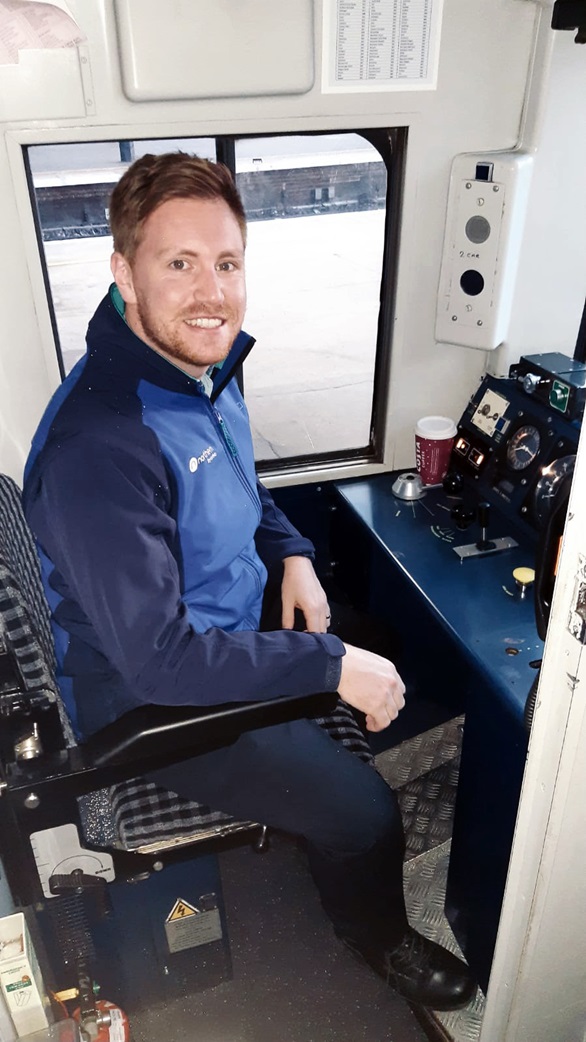 Jamie Hayhurst at the controls of a train