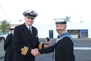 AB Andrew Fulton receiving his Iraq medal from Captain Nick Dorman