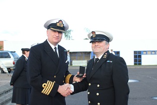 CPO David Annan receiving the third clasp to his Volunteer Reserves Service Medal from Captain Nick Dorman