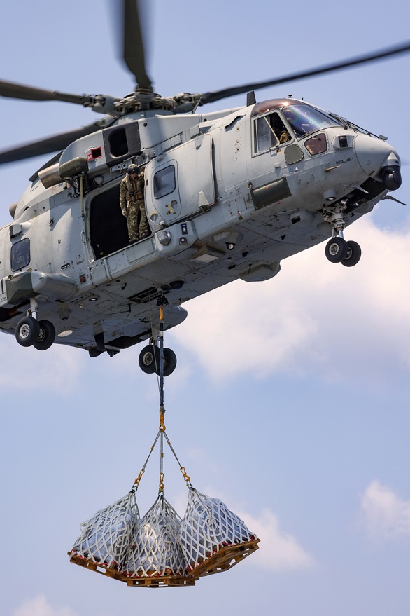 A Commando Merlin of 845 NAS delivers three underslung loads to the flagship