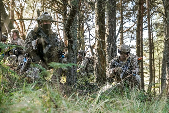 Royal Marines in the undergrowth at the Bovington Training Area during the final exercise of their eight-week boarding course