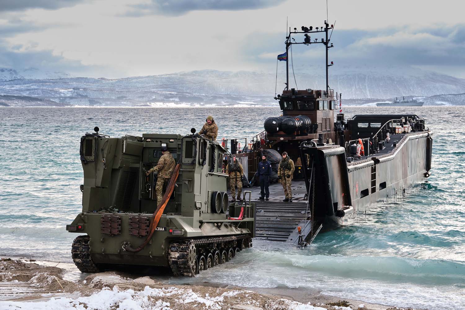 Royal Marines move their vehicles ashore after disembarking from HMS Albion. Picture: POPhot Si Ethell