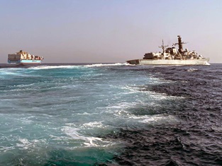 HMS Montrose in company with a merchant ship in the Gulf