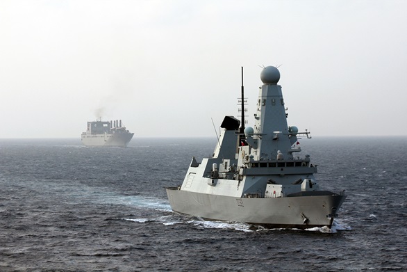 HMS Daring escorts the 62,000-tonne American military ferry/cargo ship USNS Brittin safely through ‘missile alley’