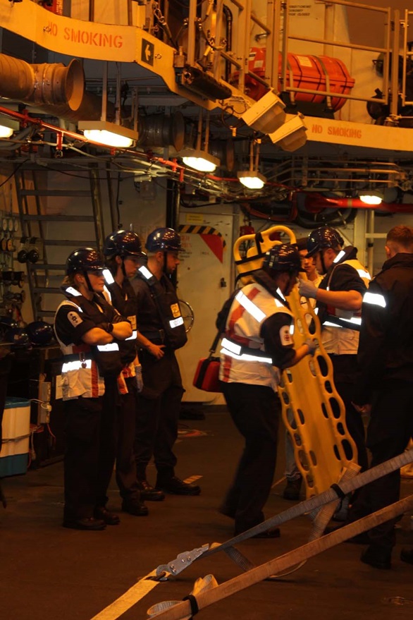 HMS Diamond's sailors get ready to launch the ship's seaboat to help the yacht