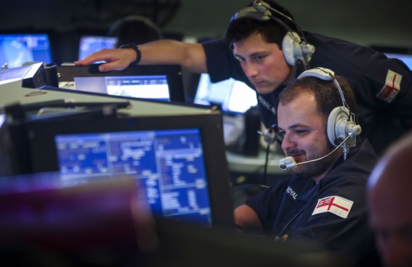 Sailors in HMS Dragon's operations room discuss a missile attack