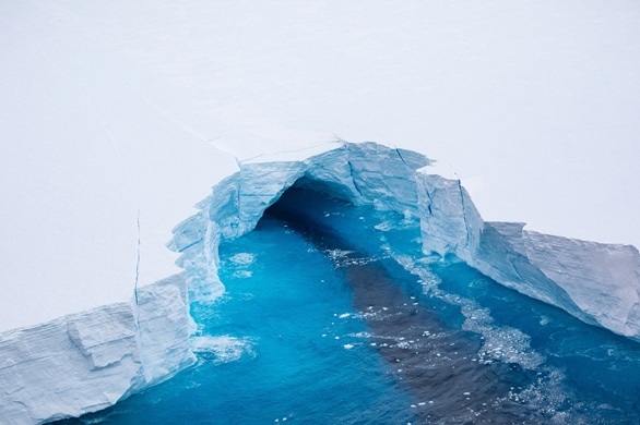 An ice tunnel carved in a section of a iceberg A68a