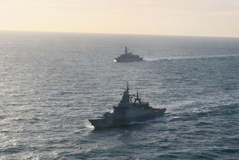 HMS Lancaster in the background shadows Russian warship Boikiy in December