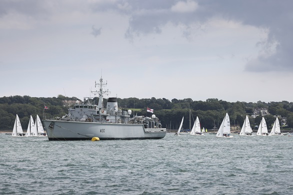 Yachts jostle for position as they pass HMS Ledbury