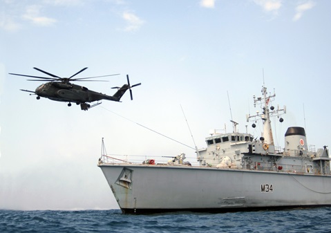 HMS Middleton conducting winching drills with a US Navy Sea Hawk helicopter