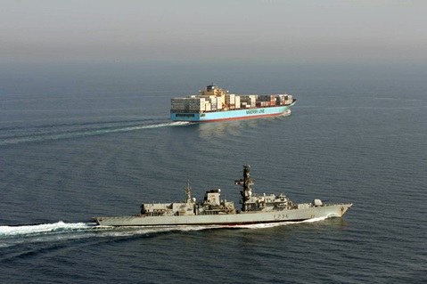 HMS Montrose shepherds a container ship in the Gulf