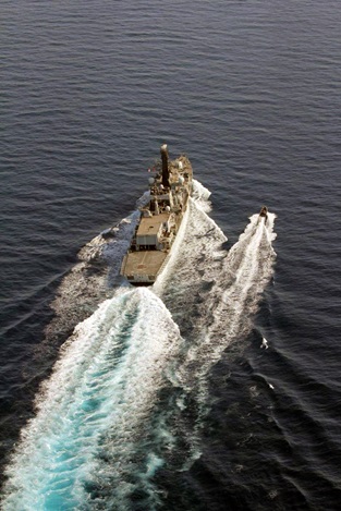 HMS Montrose seen from above moving at speed through the Gulf, accompanied by one of her Pacific 24 RIBs