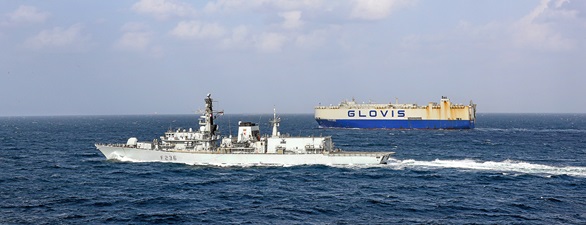 HMS Montrose accompanies a car carrier in the Gulf