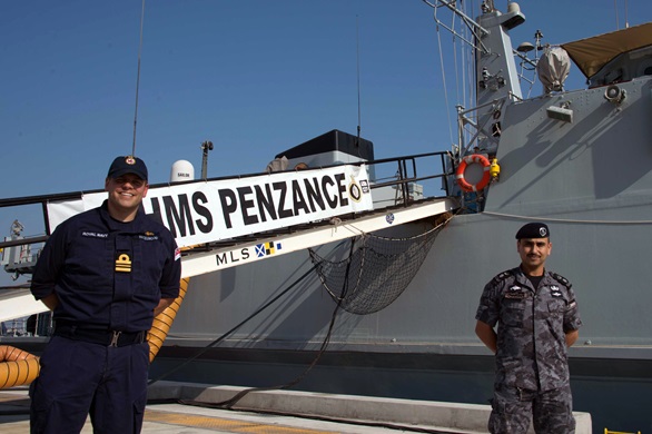 Lt Cdr Graeme Hazlewood and Cdr Mohannad Alnamat in front of HMS Penzance in Bahrain
