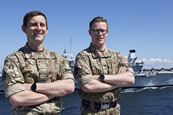 Flt Lts Chris Smith and Hayden Rose on HMS Prince of Wales with HMS QE in background