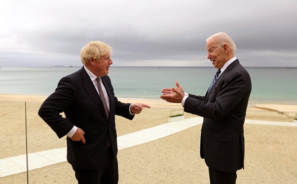 Boris Johnson and Joe Biden on the beach in Cornwall with HMS Prince of Wales on the horizon