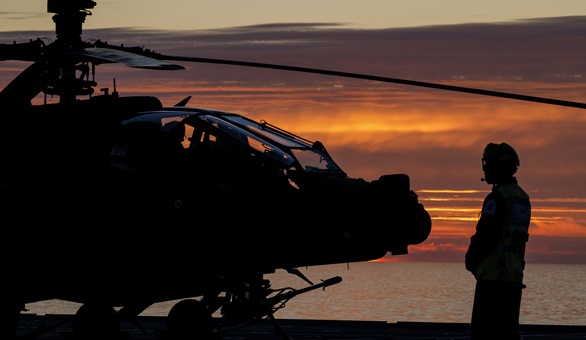 An Apache crew carries out pre-flight checks on the flight deck before a dawn sortie