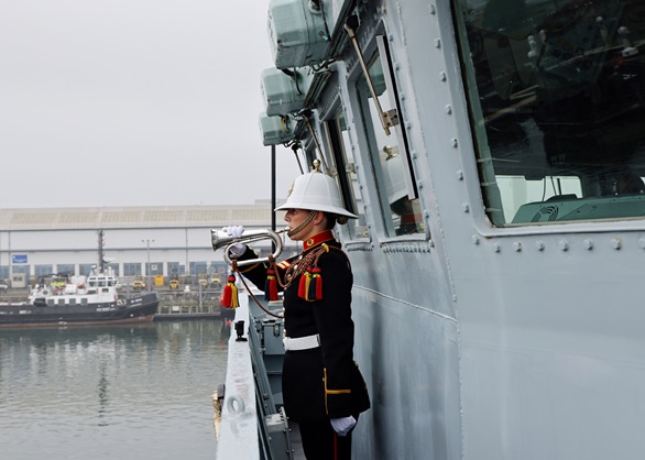 A Royal Marine Bugler performs as Richmond departs