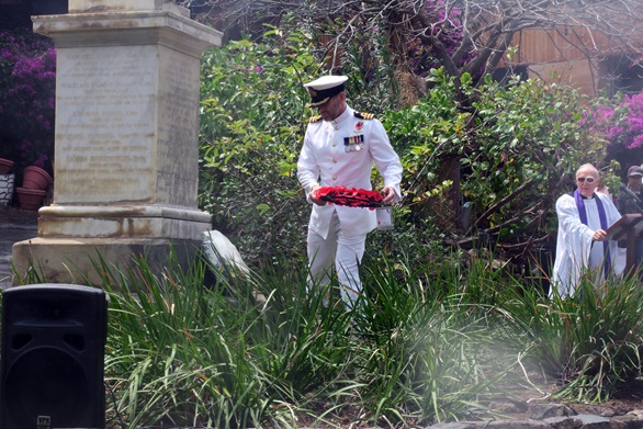Commander Tom Boeckx places a wreath on the monument to anti-slavery sailors who died aboard HMS Waterwitch