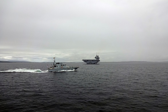 'Grey dwarf' as tiny patrol boats are overshadowed by gigantic HMS Queen Elizabeth