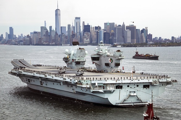 HMS Queen Elizabeth's crew line the upper deck for the ship's arrival in New York Harbour