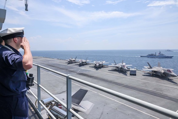 HMS Queen Elizabeth sails through the Strait of Malacca with the Malaysian Navy. Picture: POPhot Jay Allen
