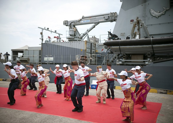 Logistics officer Lt Joe Howell (centre) shows his traditional Indonesian dancing skills